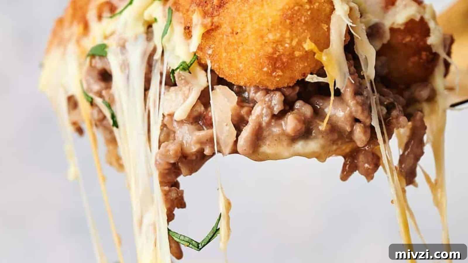 35 Comforting Casserole Recipes to Rely on Tonight 37 A serving of tater tot casserole on a spoon.