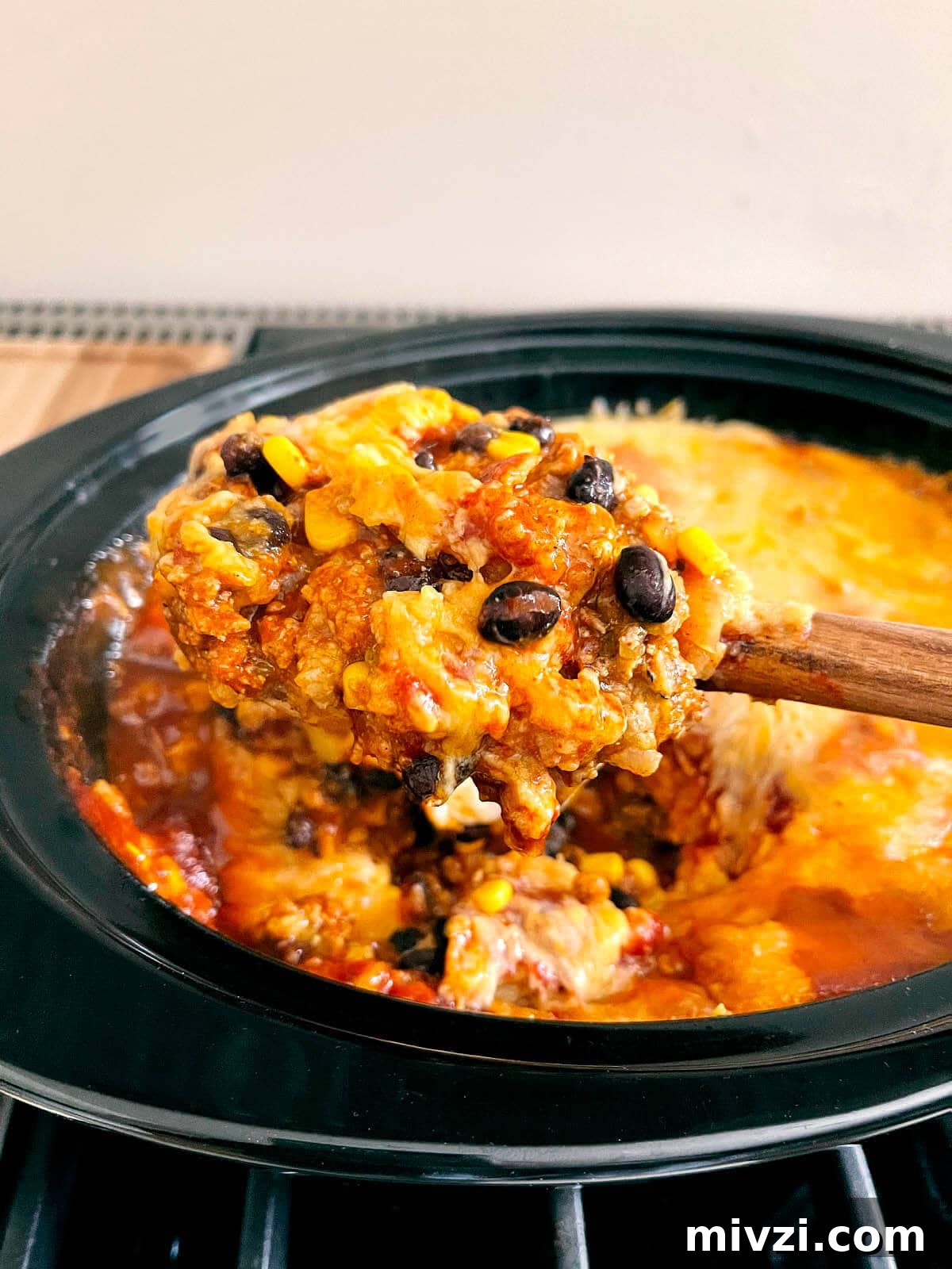 Enchilada casserole on spoon. 
