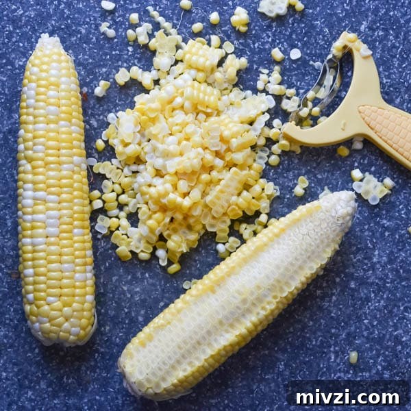 Confetti Corn: Colorful Baked Corn Recipe with Rainbow Veggies 3 corn on the cob, and corn stripper.