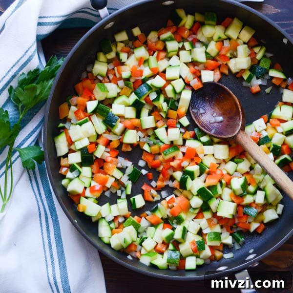 Confetti Corn: Colorful Baked Corn Recipe with Rainbow Veggies 5 chopped vegetables in a pan.