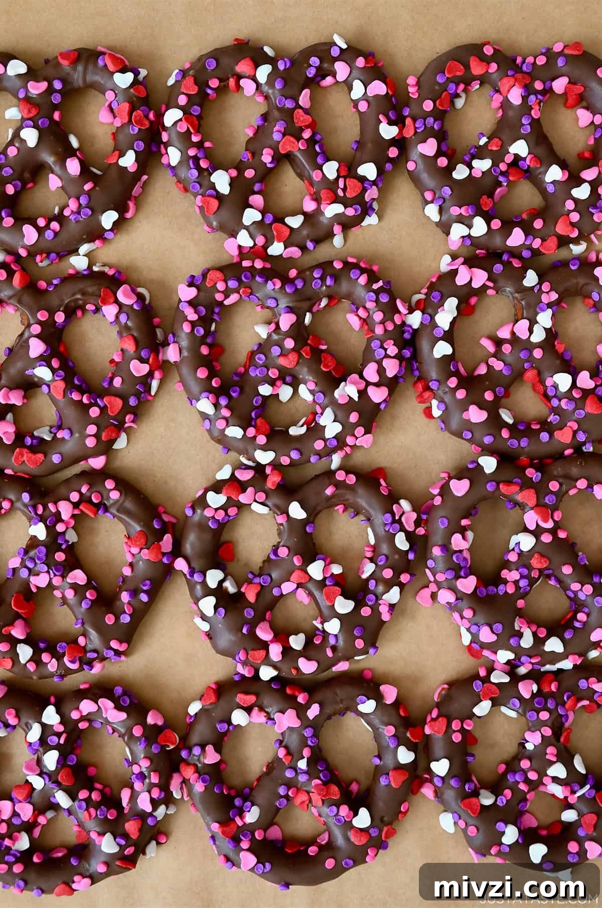 Romantic Valentine’s Day Dessert Ideas and Recipes 11 Chocolate covered pretzels with pink, red and white heart sprinkles.