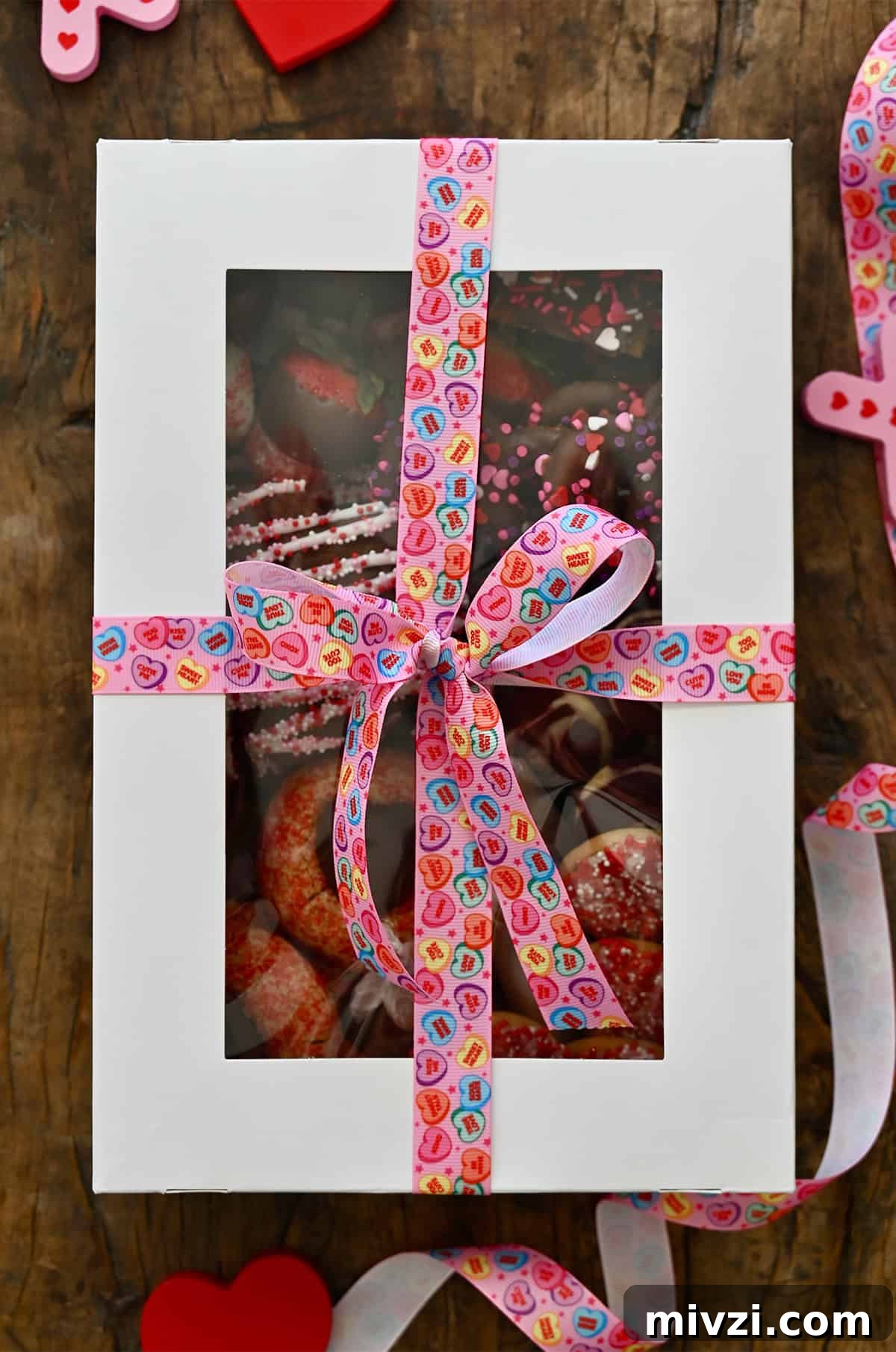 Romantic Valentine’s Day Dessert Ideas and Recipes 3 A Valentine's Day dessert box tied up with a conversation hearts ribbon.