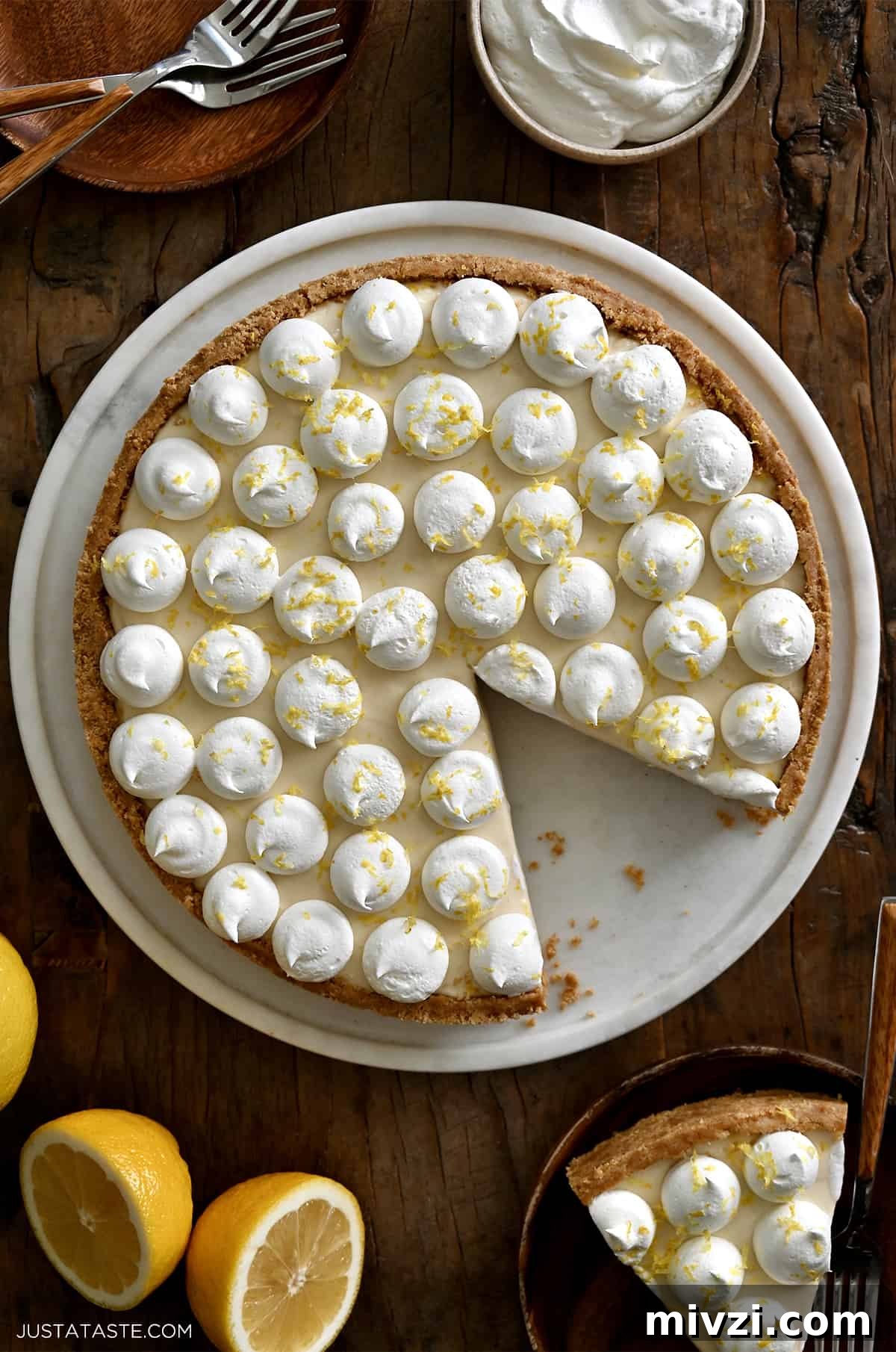 Romantic Valentine’s Day Dessert Ideas and Recipes 24 A top-down view of a cheesecake topped with dollops of whipped cream and lemon zest.