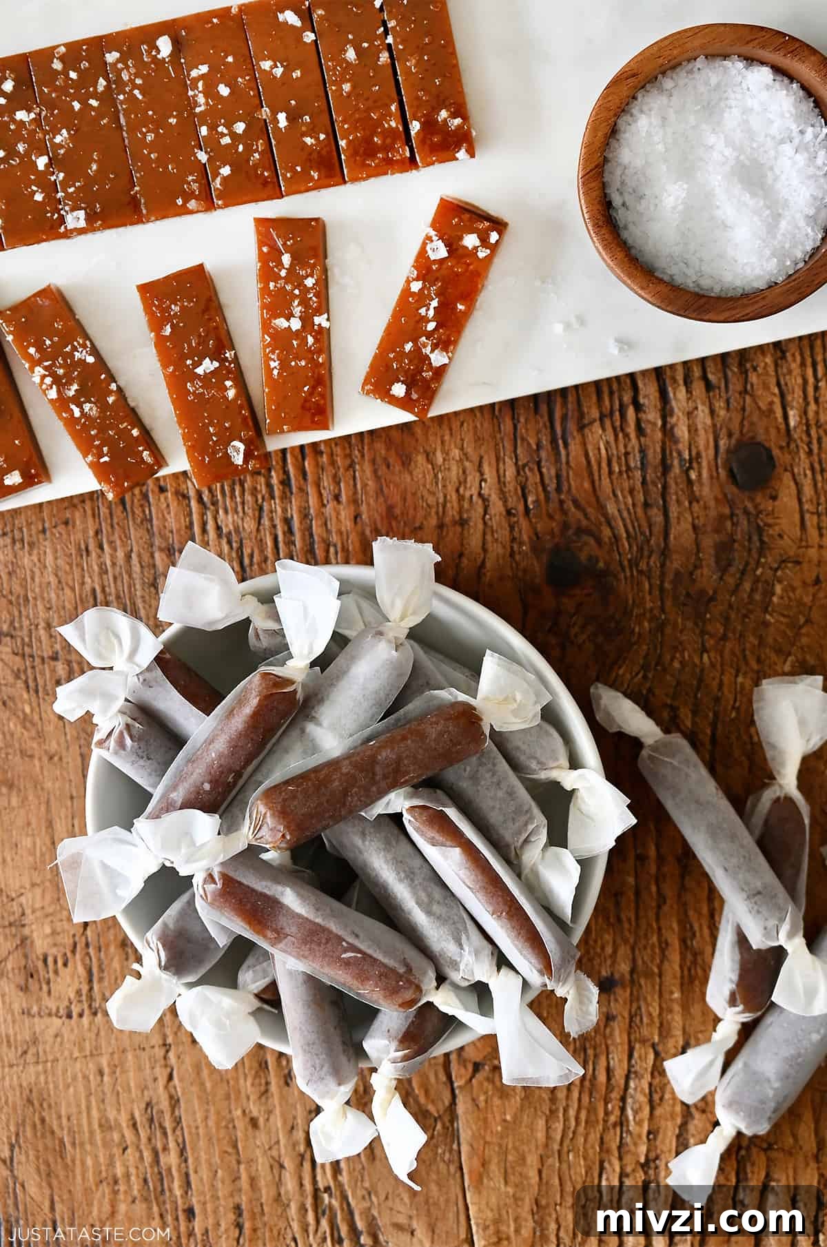 Romantic Valentine’s Day Dessert Ideas and Recipes 27 Homemade salted caramels wrapped in wax paper in a bowl next to more caramels topped with large-flake sea salt.