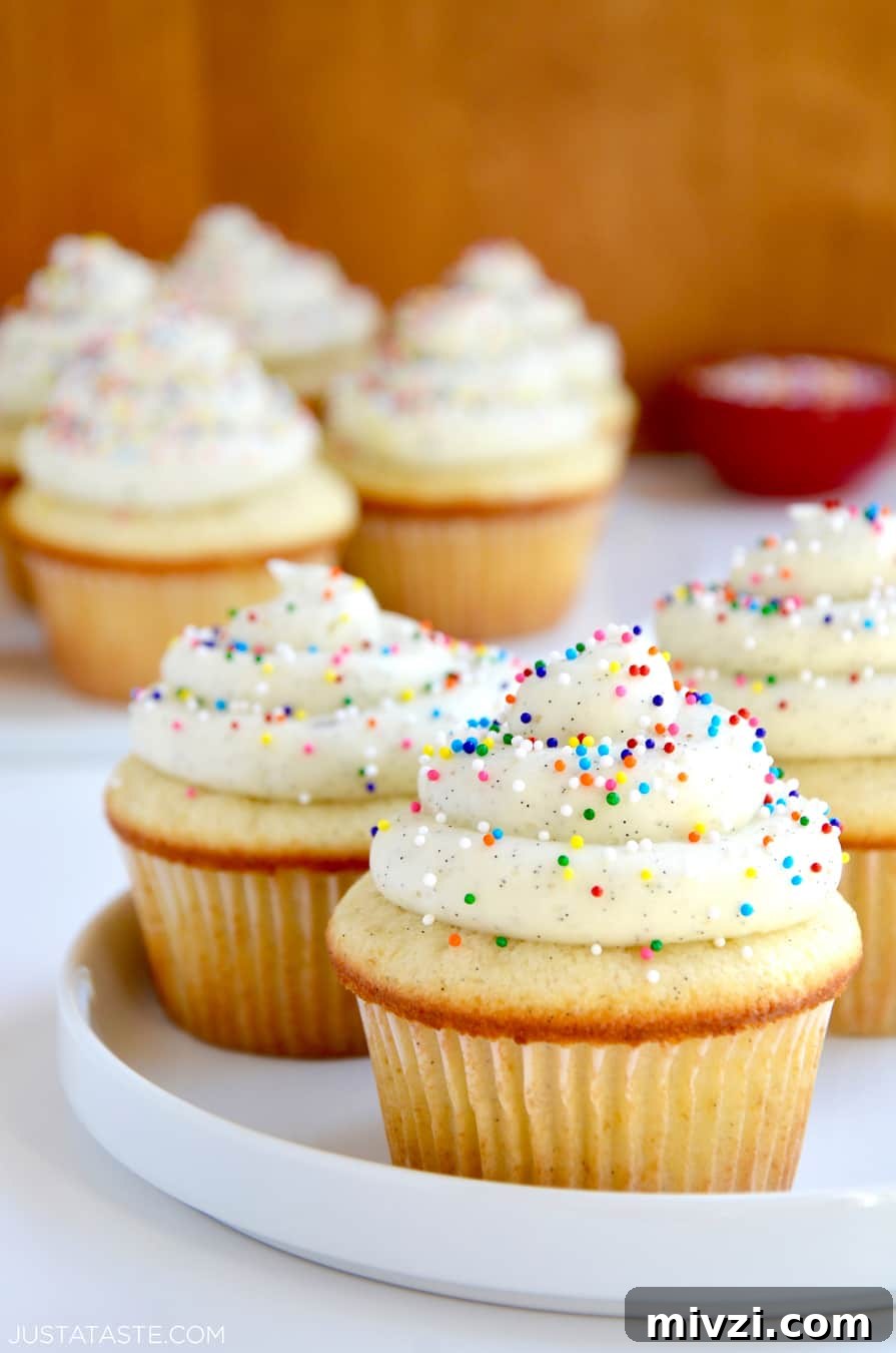 Romantic Valentine’s Day Dessert Ideas and Recipes 32 White plate containing Vanilla Bean Cupcakes with Buttercream Frosting and rainbow sprinkles