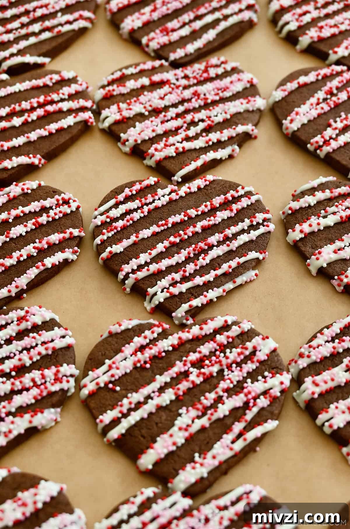 Romantic Valentine’s Day Dessert Ideas and Recipes 9 Chocolate sugar cookies with icing and red and white sprinkles.