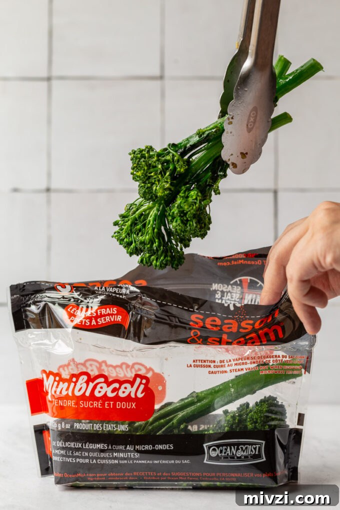 baby broccoli being pulled out of an ocean mist steam bag