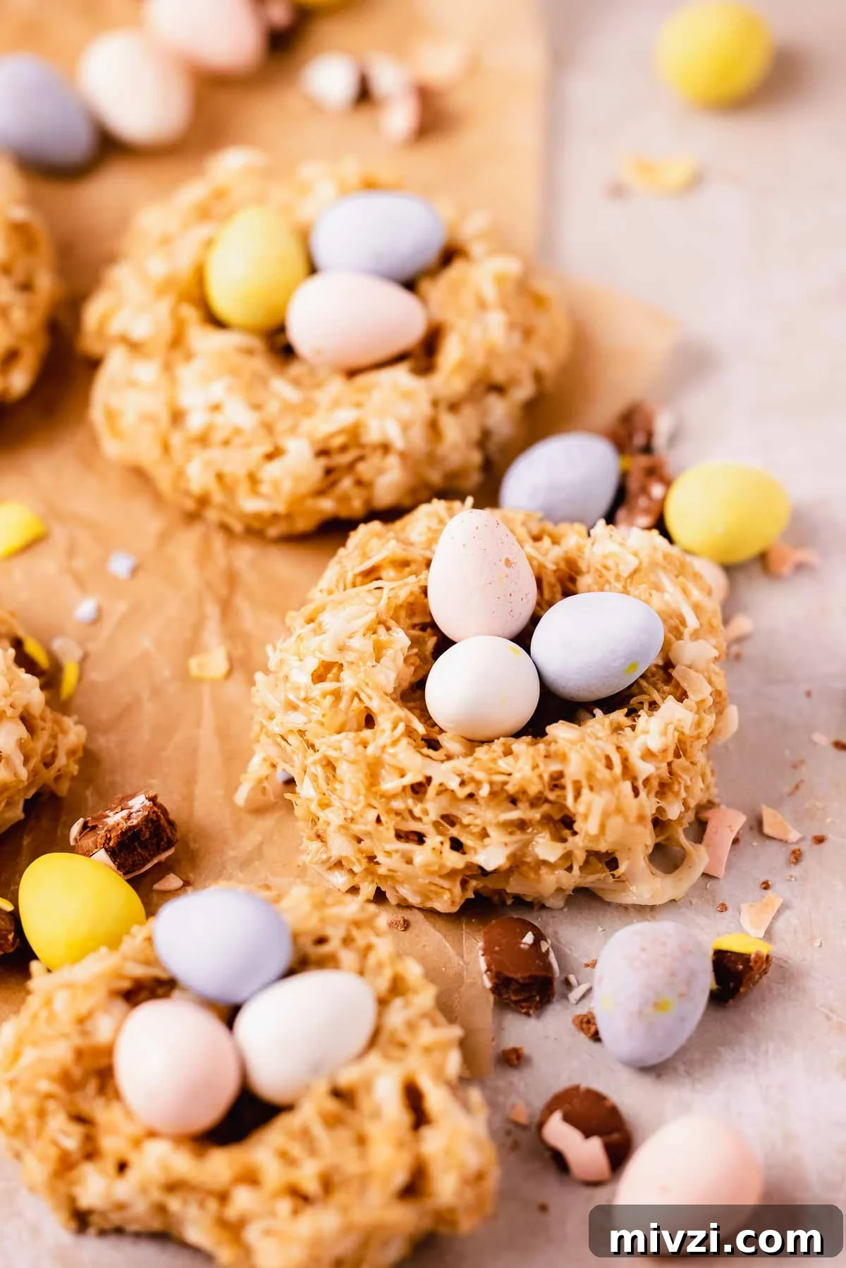 birds nest cookies on parchment paper with speckled mini eggs