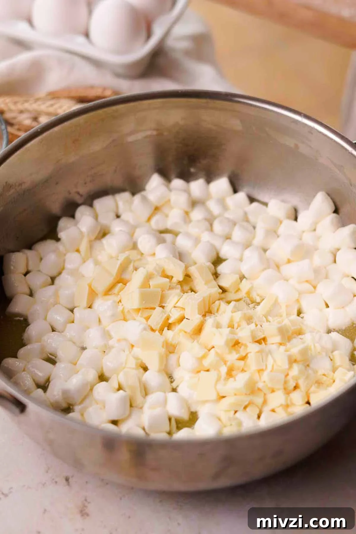 combining butter, marshmallows, and white chocolate in a pan