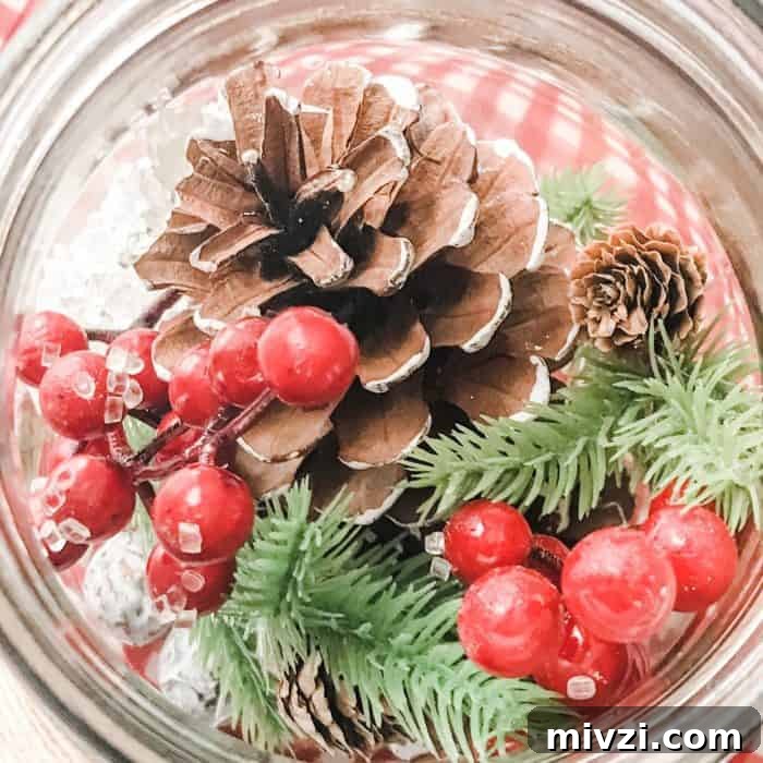 Christmas Potpourri Diffuser Ideas for Festive Home Fragrance 8 berries, pinecones, greenery, and snow crystals in mason jar