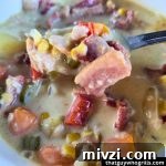 Creative Recipes for Leftover Salmon: 25 Ways to Reuse Fillets 9 Smoked salmon chowder in a white bowl with a spoon full over the bowl