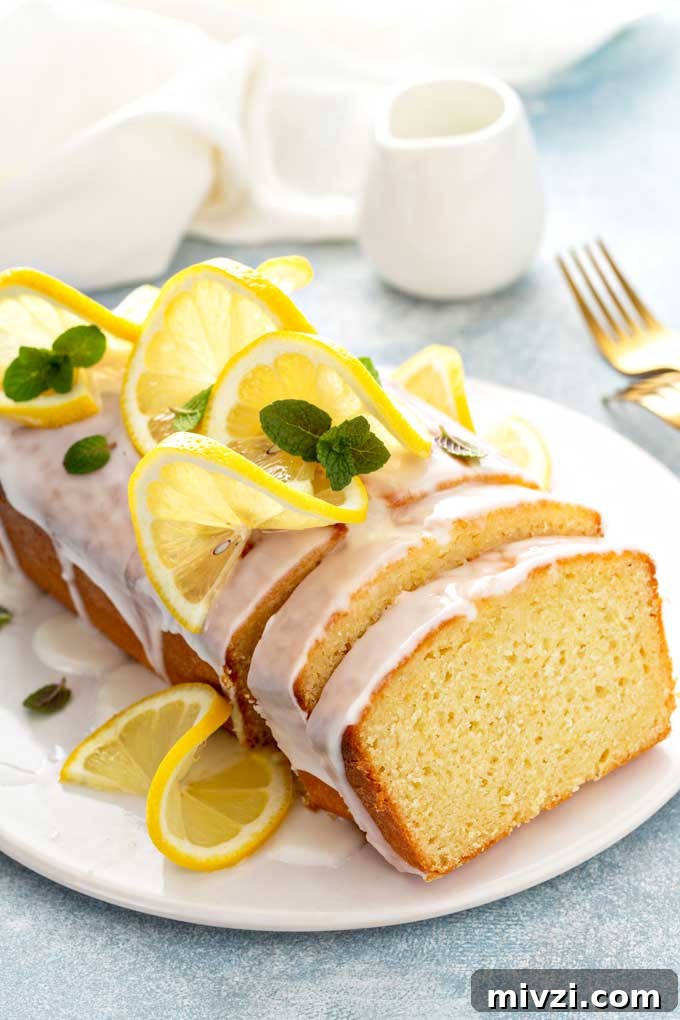 Tangy Lemon Loaf with Zesty Lemon Glaze 2 A loaf of lemon quick bread with glaze sliced.