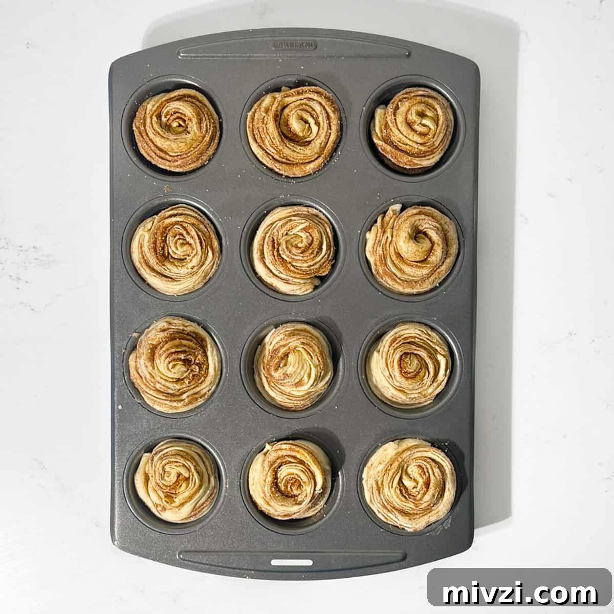 Canned Crescent Dough Cruffins Recipe: Flaky Homemade Pastry in Minutes 18 Rolled up cruffins in a muffin tin, ready for the oven.