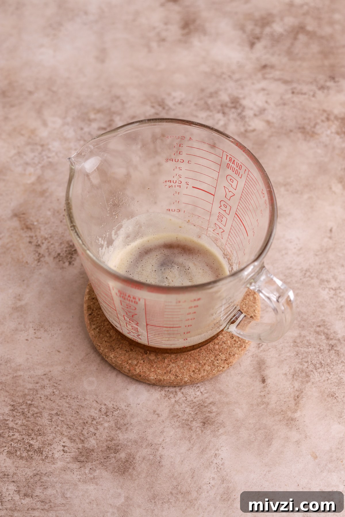 Brown Butter Cinnamon Rolls with Gooey Caramelized Swirl 4 Brown butter in a glass measuring cup.