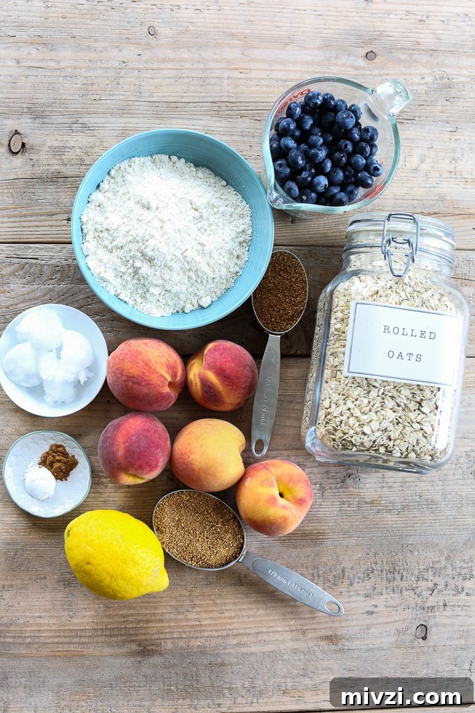 overhead shot of ingredients for healthy crisp recipe. Peaches blueberries flour oatmeal lemon coconut oil sugar
