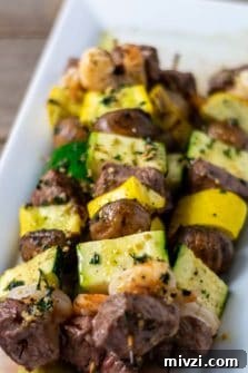 Surf and Turf Shrimp & Steak Kabobs Recipe for Grilling 9 Grilled Steak and Shrimp Kabobs on a plate.