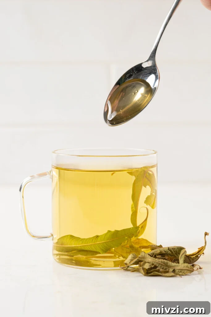 honey mixing into a cup of tea