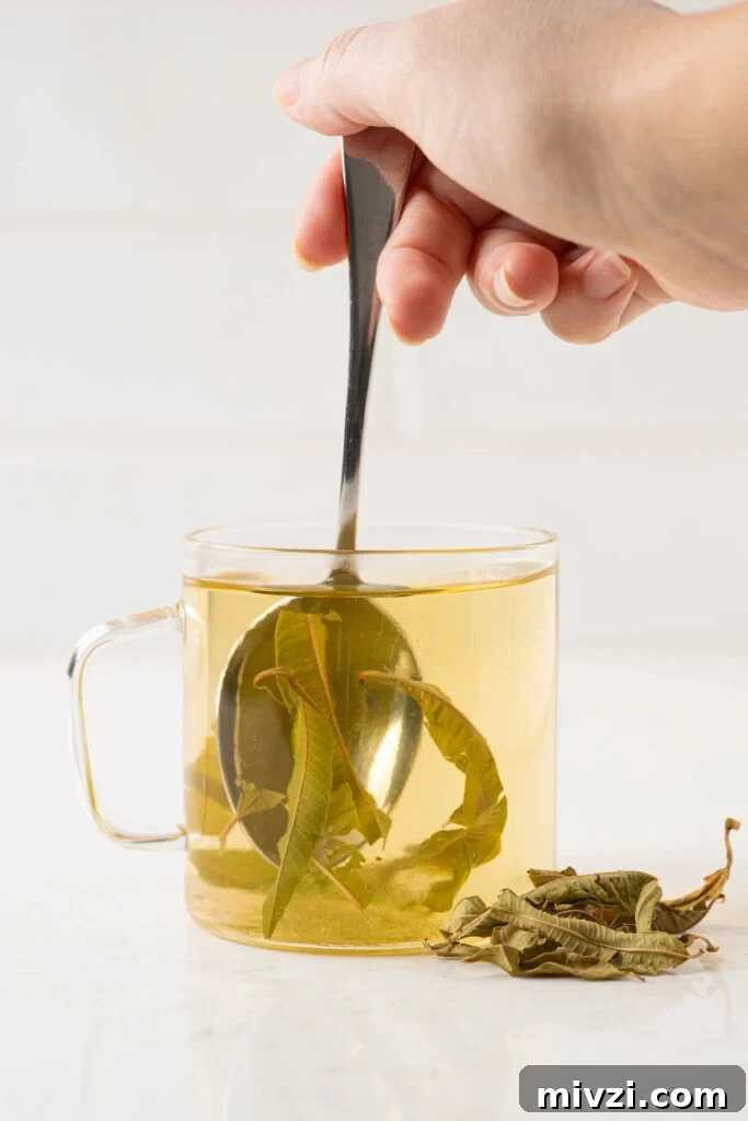 honey mixing into a cup of tea
