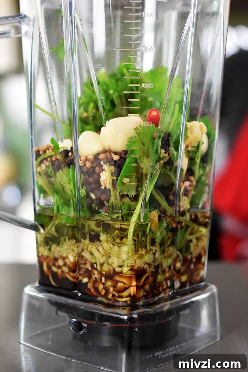 Gregory Gourdet’s Favorite Grilled Chicken Recipe 5 Side view of a blender filled with the marinade ingredients for Gregory Gourdet's favorite grilled chicken.