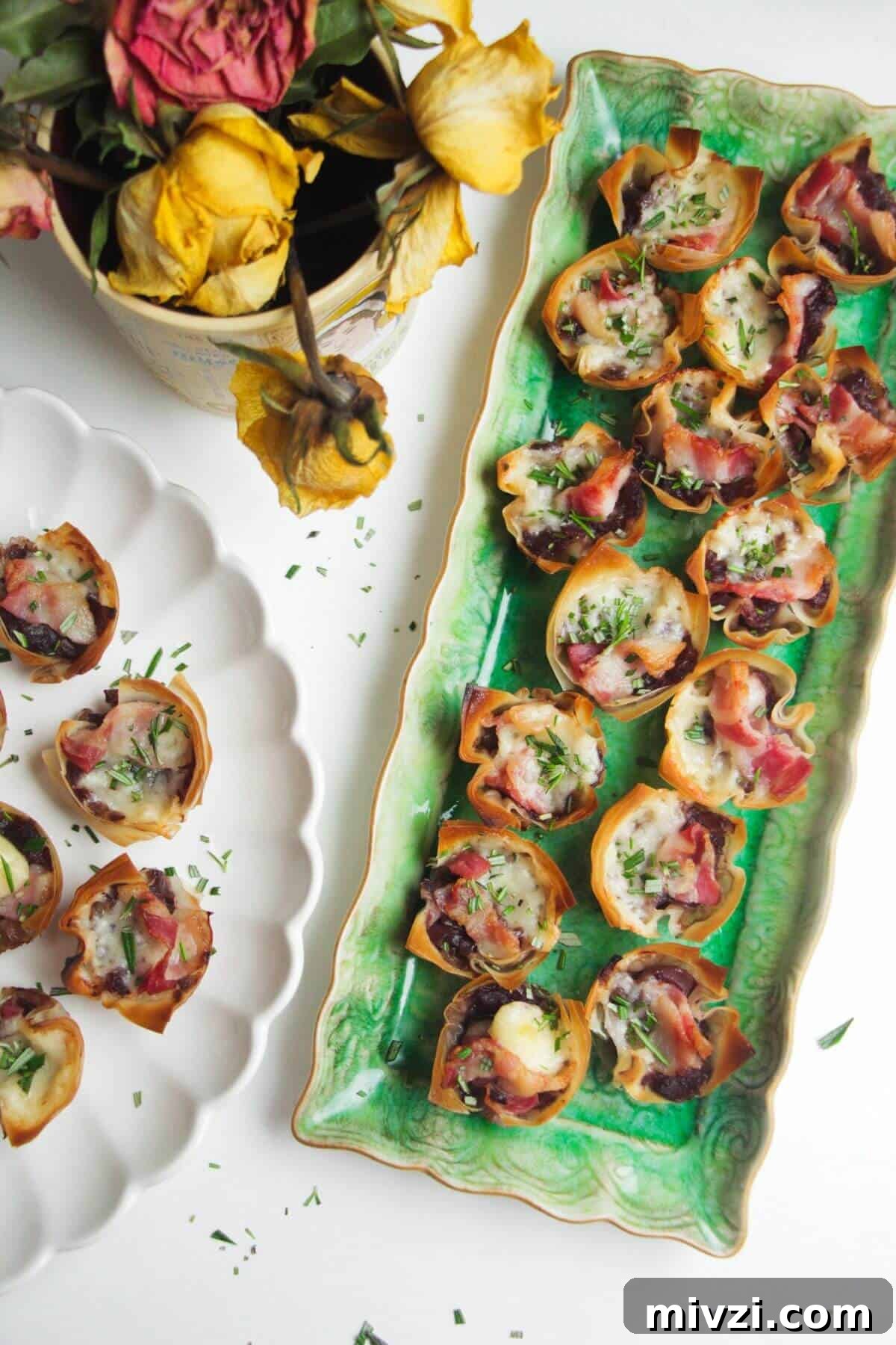 Caramelized onion filo bites on a green plate.