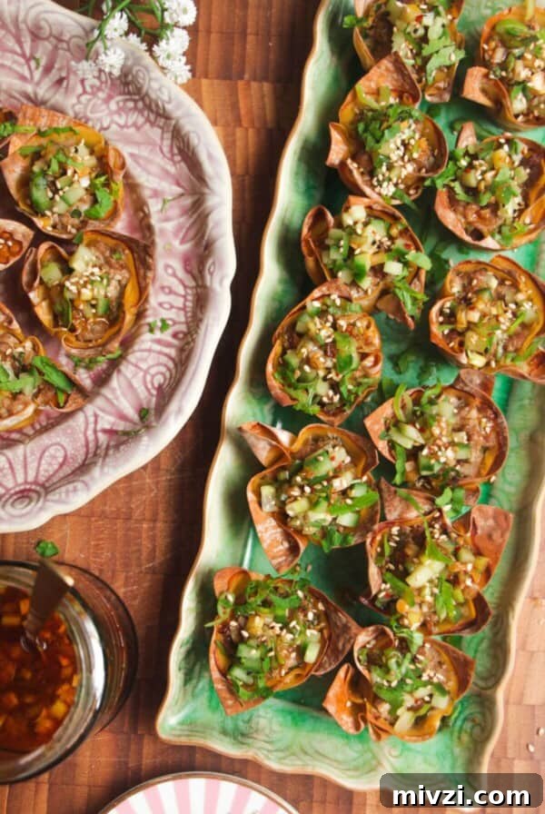 Mini dumpling cups on a green plate.