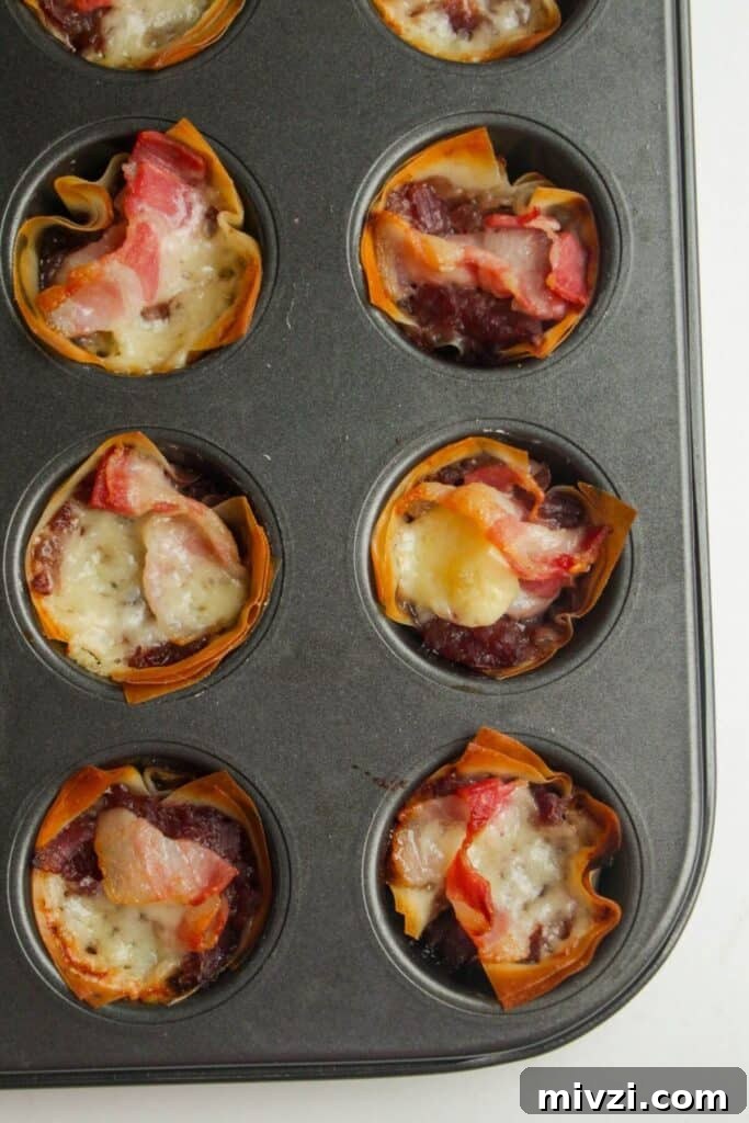 Close up of mini filo bites in a muffin tin.