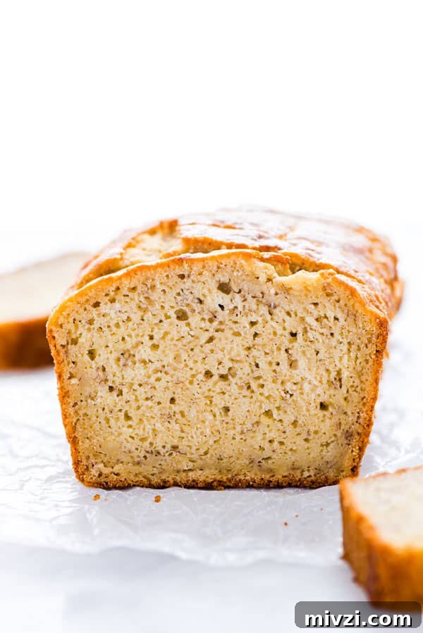 Gluten-Free Sourdough Banana Bread Recipe for Moist Loaves 2 A loaf of Gluten Free Sourdough Banana Bread sliced on a piece of wax paper