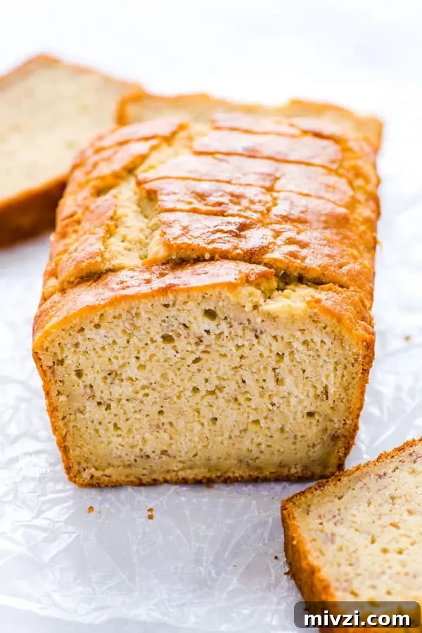 Gluten-Free Sourdough Banana Bread Recipe for Moist Loaves 3 a loaf of Gluten Free Sourdough Discard Banana Bread on a piece of wax paper