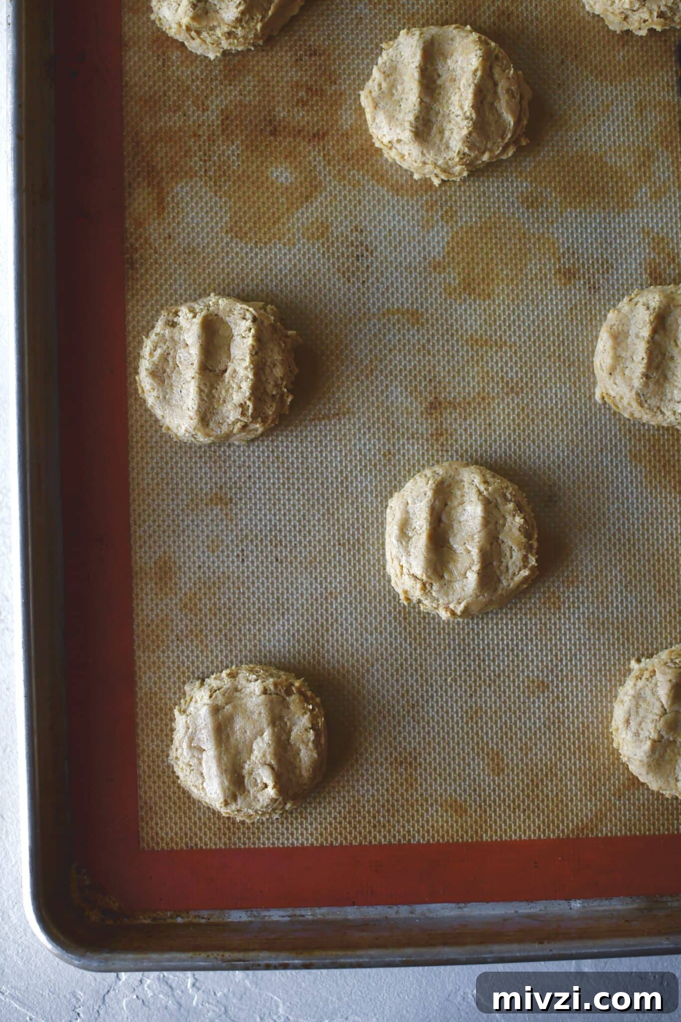 Pumpkin Whoopie Pies Recipe: Soft Spiced Cream-Filled Treats 7 Whoopie pies portioned on a sheet pan and lightly pressed down, before baking.