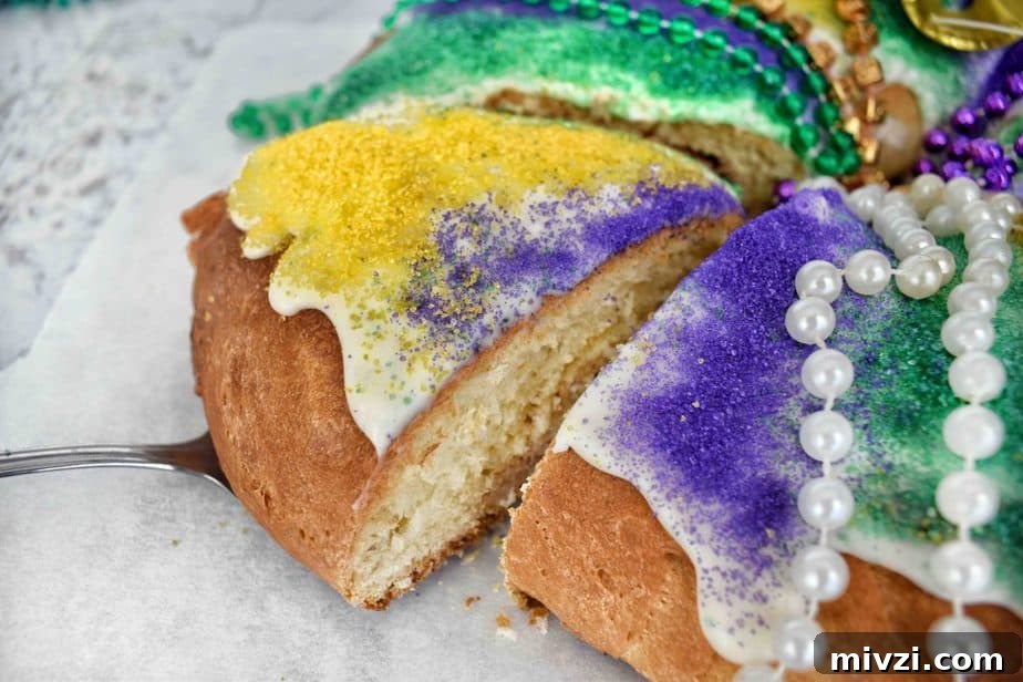 Authentic Mardi Gras King Cake Recipe: Traditional New Orleans Flavor 6 slice being removed from a king cake ring with colored sanding sugar