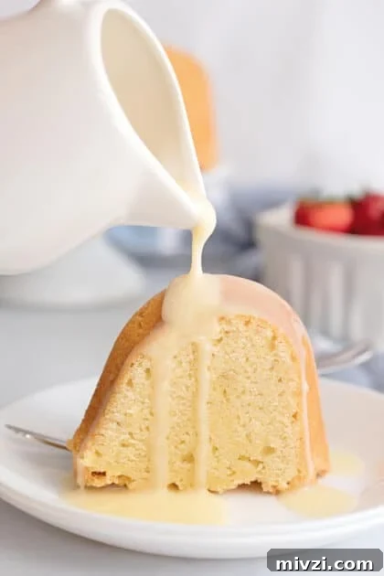Pouring custard sauce over slice of pound cake.