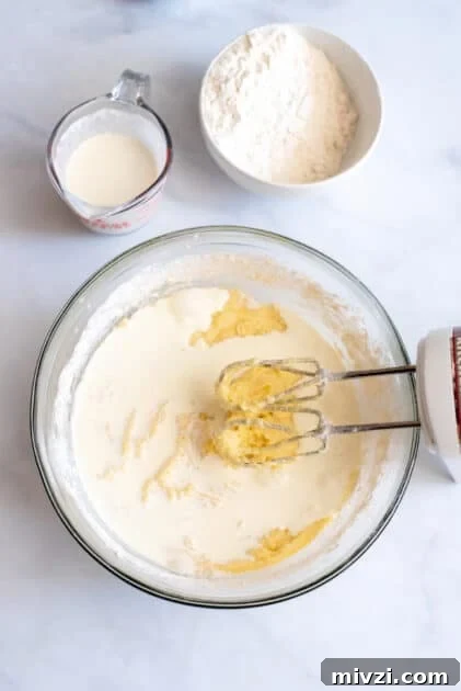 Alternate between whipping cream and flour.