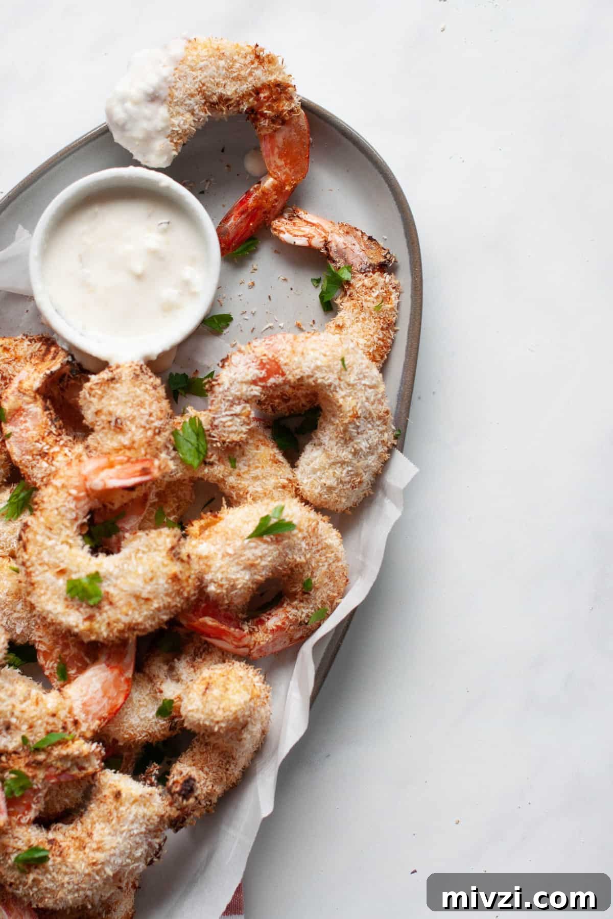 Crispy Coconut Shrimp Made in the Air Fryer 6 air fried coconut shrimp on plate