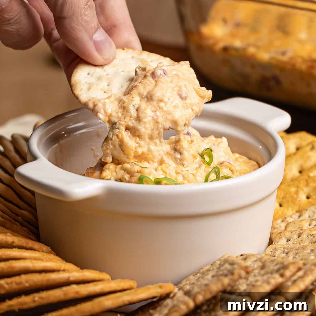 A scoop of slow cooker reuben dip on a tortilla chip.