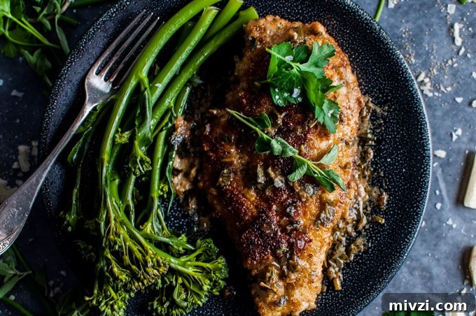 Parmesan Crusted Chicken with Fresh Herb Sauce 4 close-up of parmesan crusted chicken breasts with a fresh herb sauce