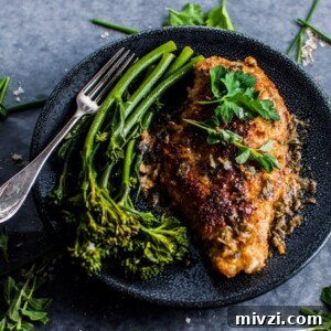 Parmesan crusted chicken breasts with a fresh herb sauce makes a wonderful weeknight meal.
