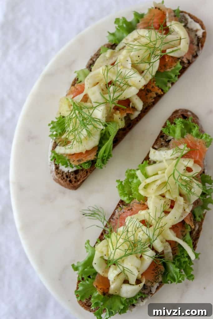An open sandwich with smoked salmon and fennel on a plate