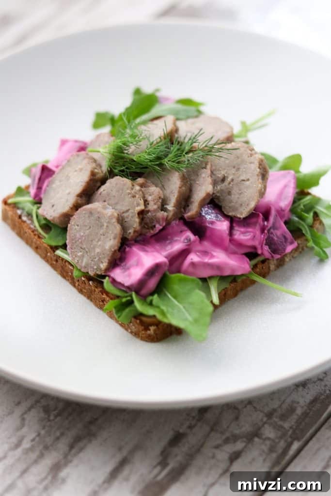 An open sandwich with meatballs and beet salad on a plate