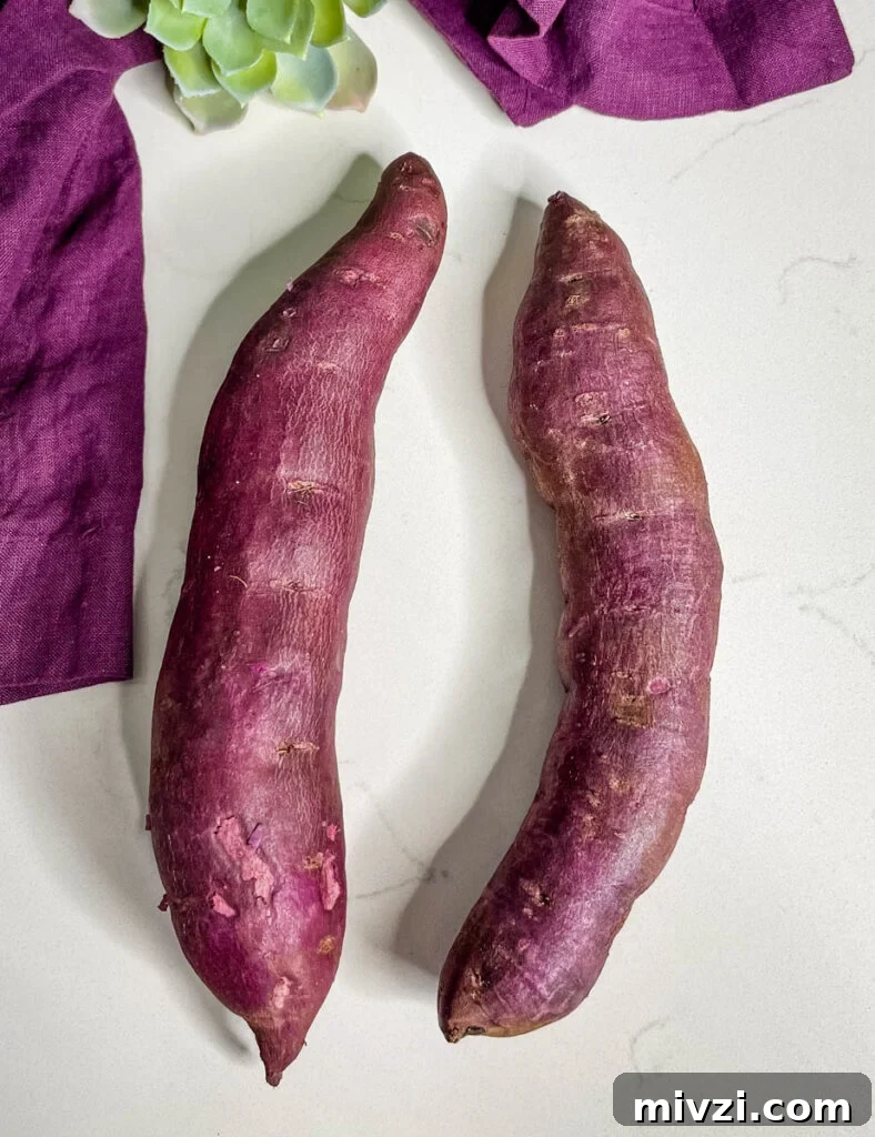 How to Cook Purple Sweet Potatoes: Simple Recipes & Techniques 3 raw Stokes purple sweet potato on a flat surface