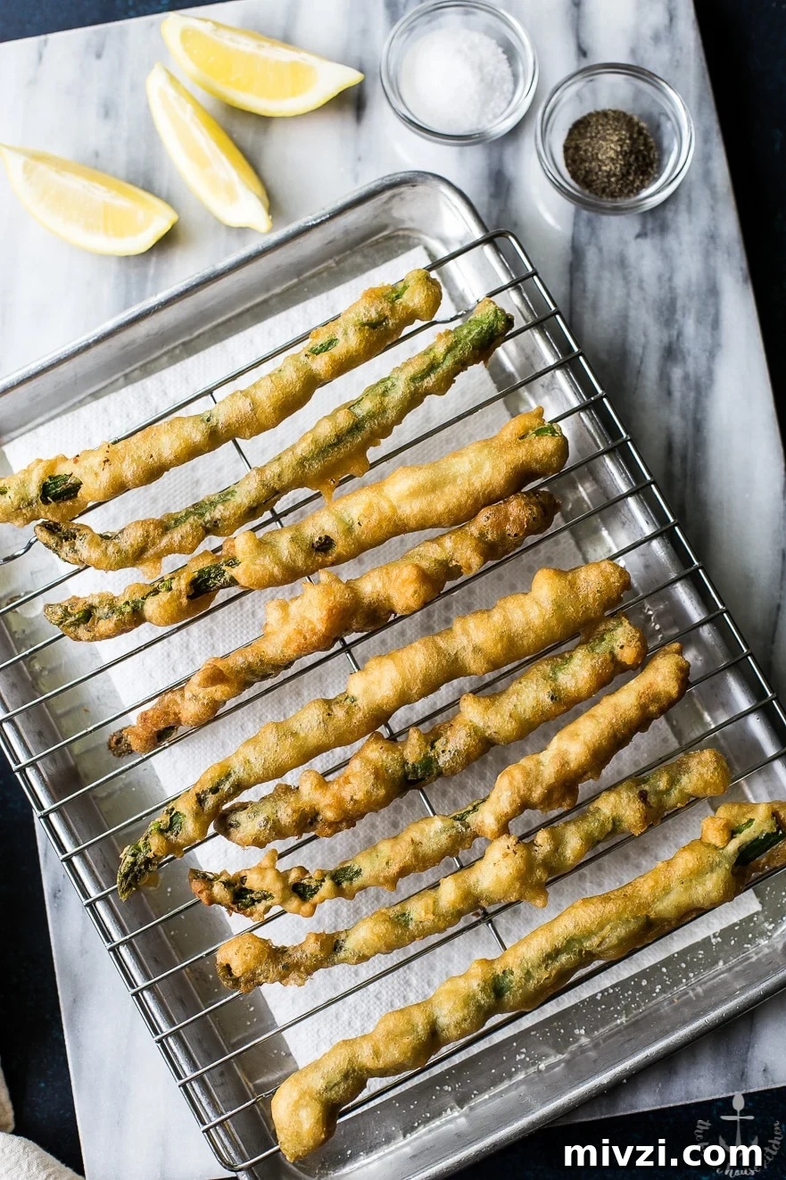 Crispy Asparagus Tempura with Tangy Horseradish Cream Sauce 8 Overhead photo of asparagus tempura on a rack on a silver tray