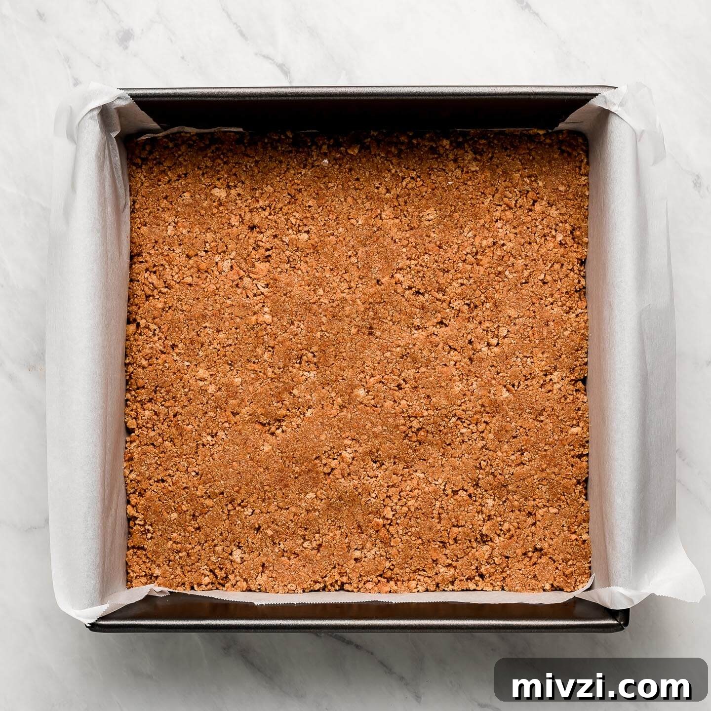Graham cracker crumbs pressed into the bottom of the pan.