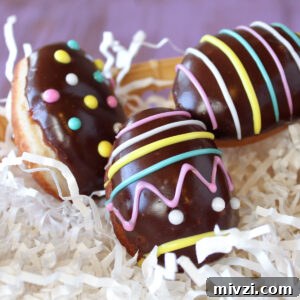 Easter Chocolate Push-Up Pops: Festive Treats for Kids 12 Easter Egg Doughnuts on white paper shreds.