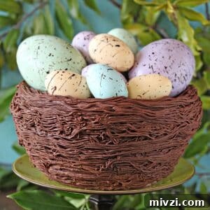 Easter Chocolate Push-Up Pops: Festive Treats for Kids 18 Close up of Easter Nest Cake on a green cake stand surrounded by greenery.