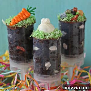Easter Chocolate Push-Up Pops: Festive Treats for Kids 19 Two push-up pops filled with chocolate cake and topped with bunny ears and a chocolate carrot.