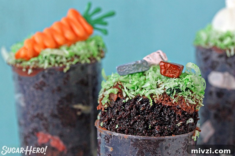 Easter Chocolate Push-Up Pops: Festive Treats for Kids 4 Two Easter push-up pops filled with chocolate cake, one is topped with bunny ears and one is topped with chocolate rocks.