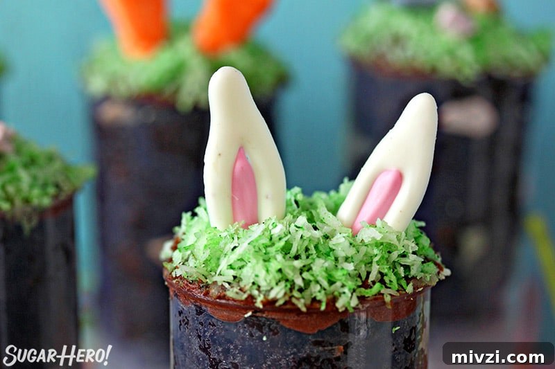 Easter Chocolate Push-Up Pops: Festive Treats for Kids 9 Close up of Easter Push-Up Pop topped with bunny ears made out of candy melt.