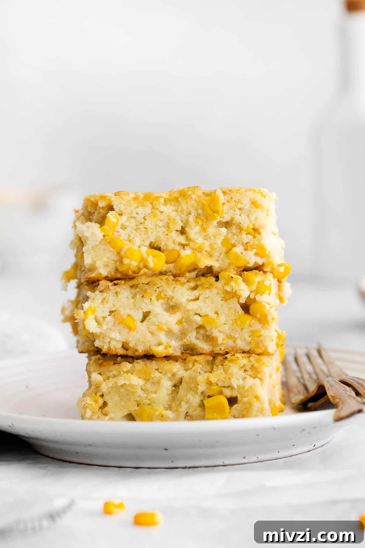 Cheesy Gluten-Free Corn Casserole Recipe for Every Occasion 9 Gluten-free corn casserole slices stacked on a plate
