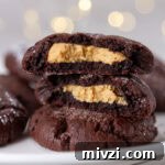 square crop of cookies stacked on top of each other the top one if broken in half so you can see the peanut butter filling.