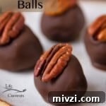 Pecan Bourbon Balls candies with a pecan half on top on a white plate that's set on a black wire plate and the title is on the image