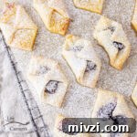 square crop of jam filled cream cheese cookies cooling on a wire rack.